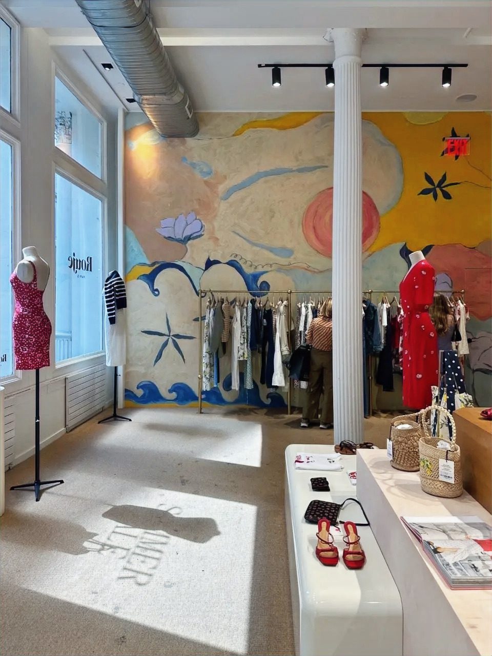 Front-of-house sales floor: full-height fresco mural and flu